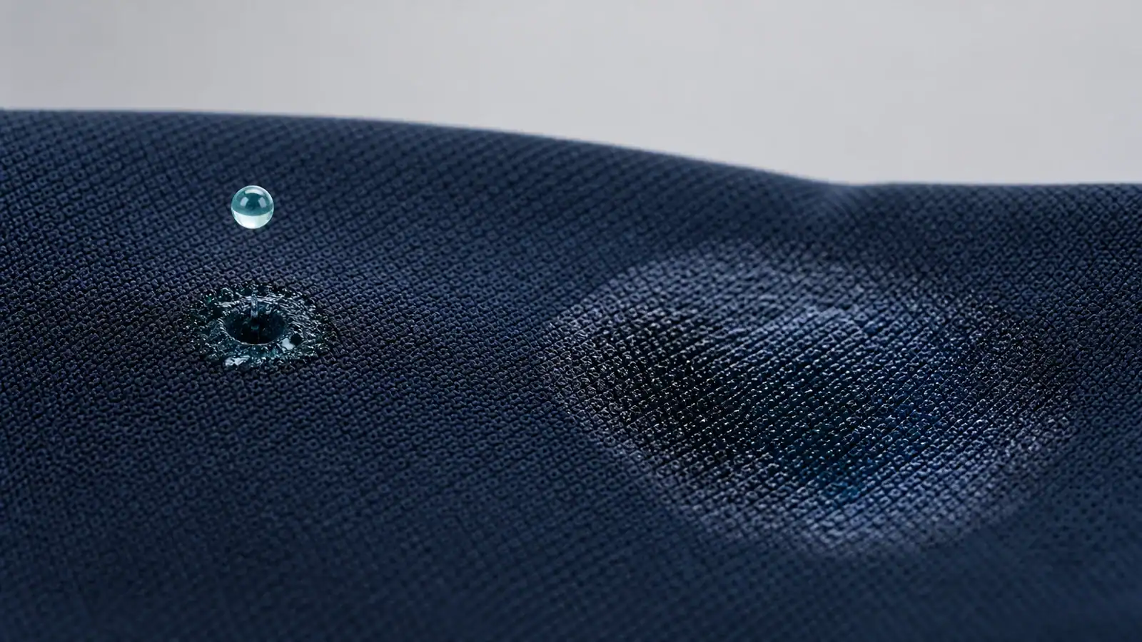 Close view of liquid spreading across the outer face of a technical knit fabric