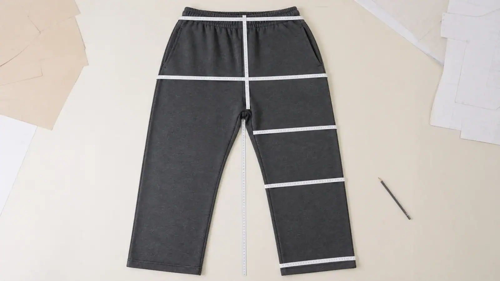 Custom sports pants with white seam accents on dark fabric for activewear.