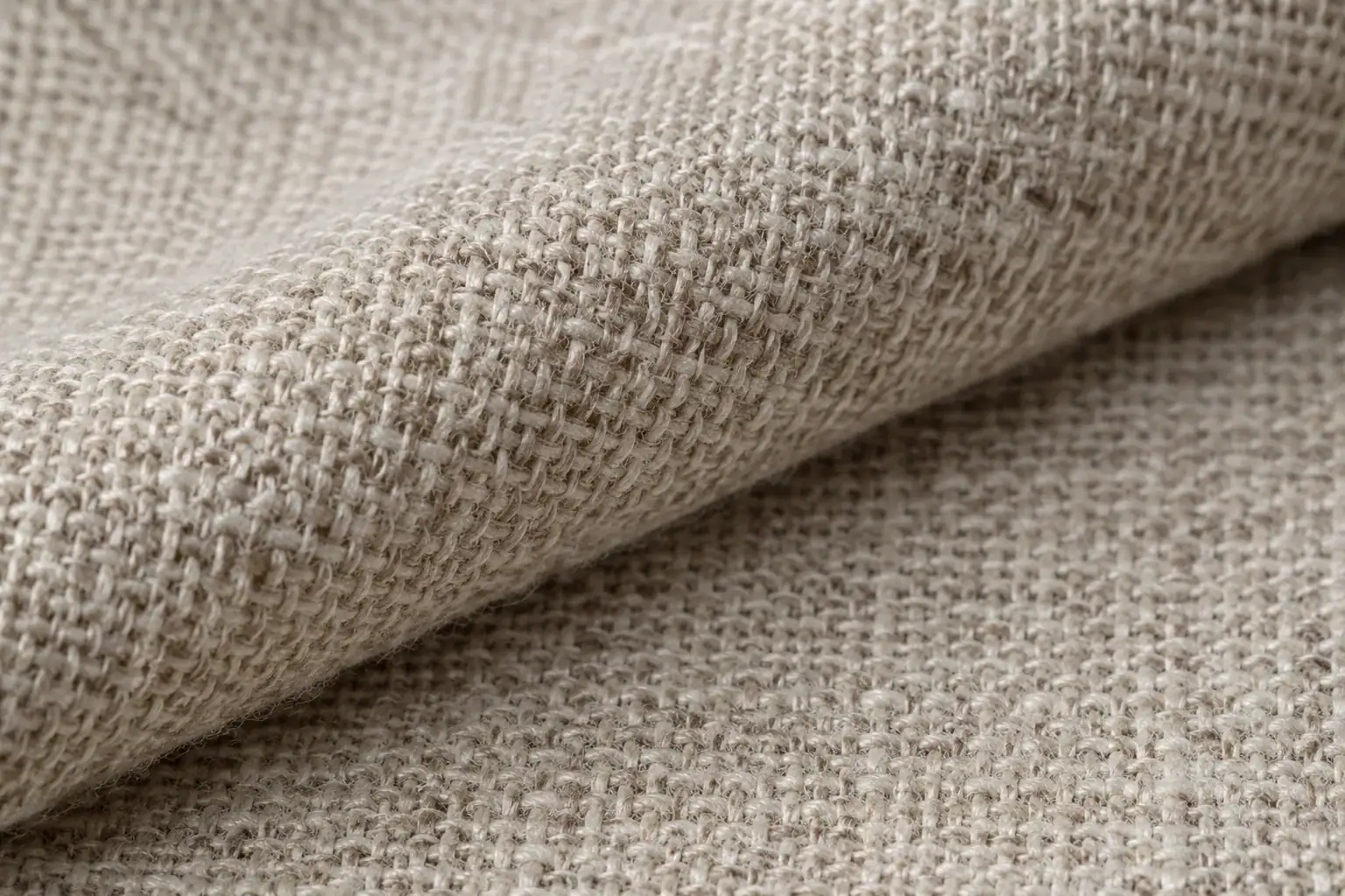 Detailed view of beige poplin fabric texture for clothing manufacturing.
